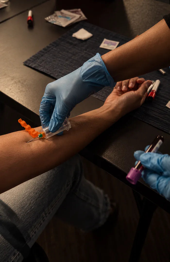 Blood being drawn from a patient’s arm for the AIWO 100 panel