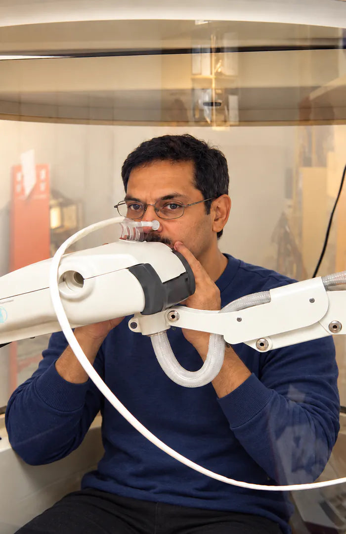 A man breathing into a pulmonary function testing device