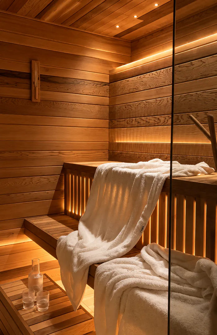 Towels laid on a bench inside a wooden sauna